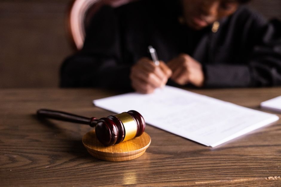 A formalização da sentença estrangeira exige validação pelo sistema jurídico brasileiro. Juiz assinando sentença judicial em tribunal com luz ambiente focada